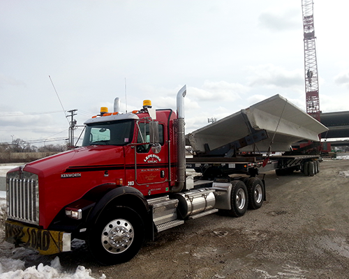 LeFebvre truck hauling commercial concrete building component.png