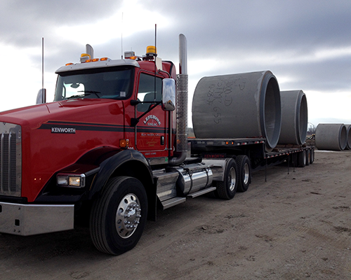 truck-transporting-concrete-pipe-2.png